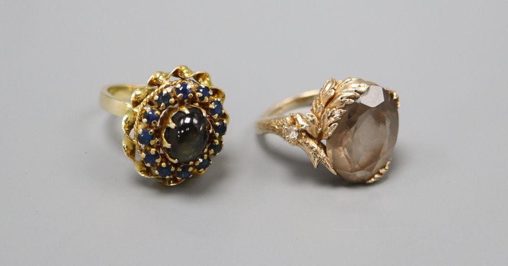 An 18k gold cabochon and sapphire cluster ring, size L, gross 5.9 grams and a 9ct. gold gem set dress ring, size M, gross 6.8 grams